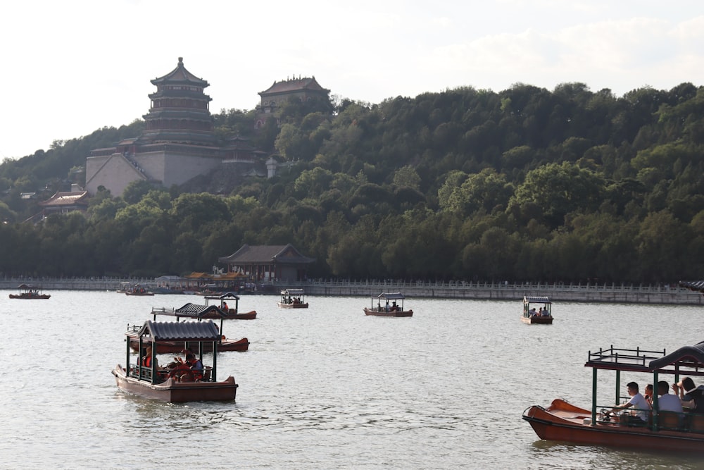 a group of boats floating on top of a lake