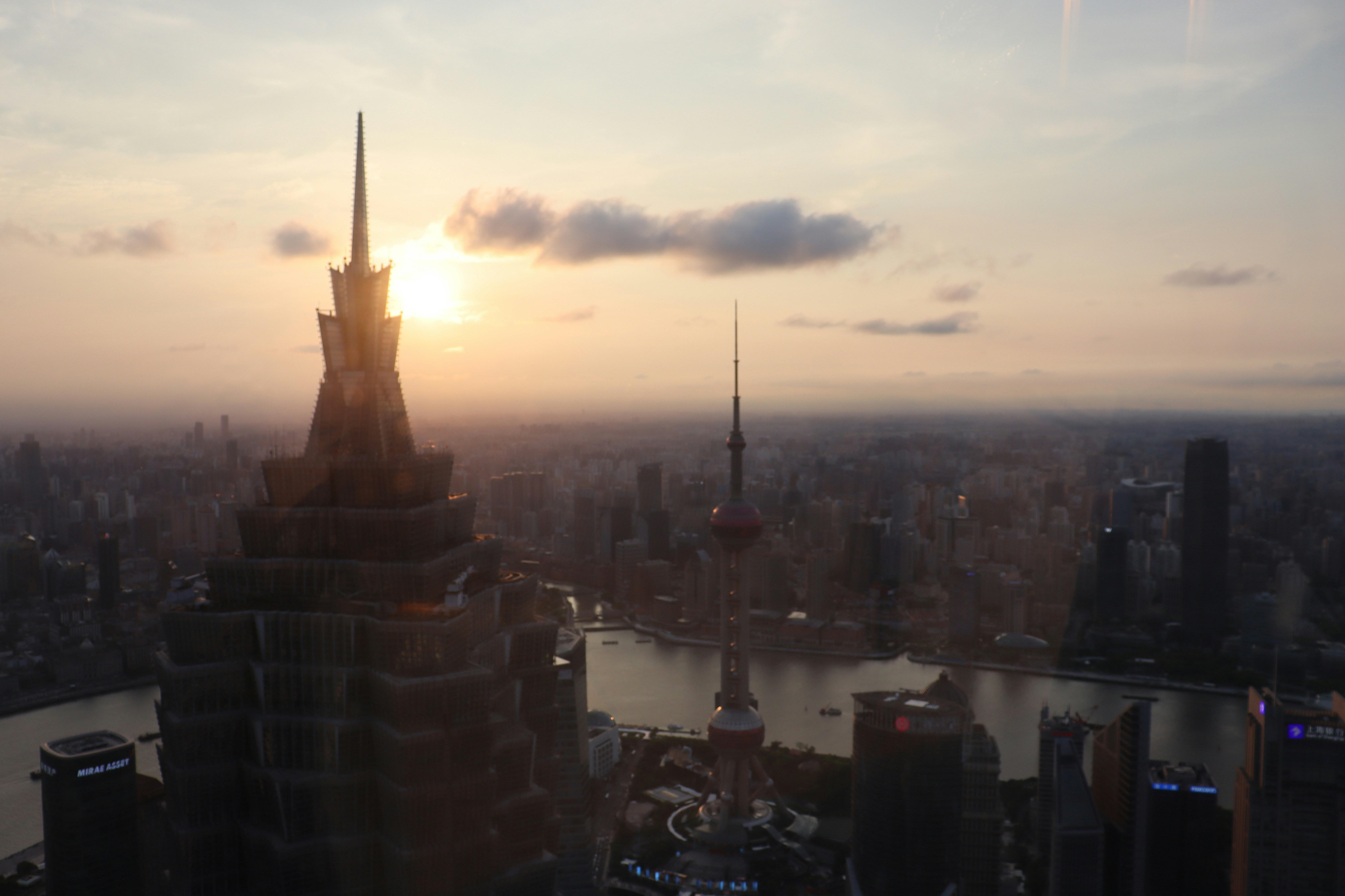 the sun is setting over a large city