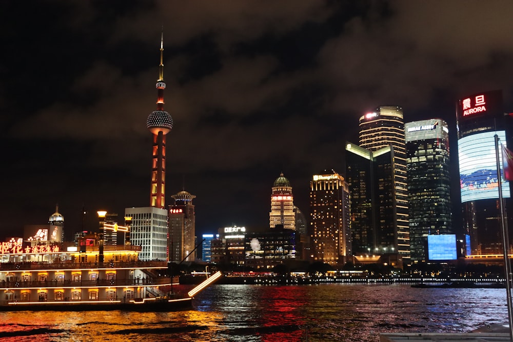 a boat traveling down a river next to tall buildings