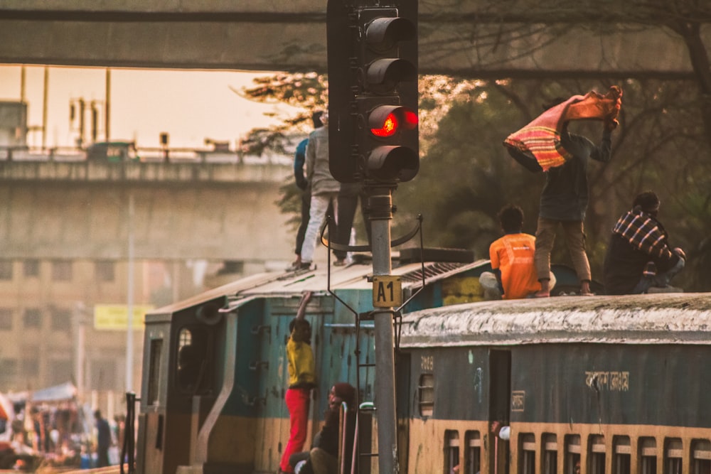 a group of people standing on top of a train