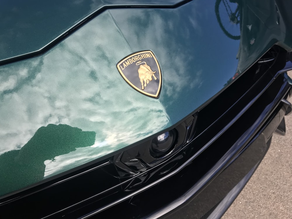 a close up of the hood of a green sports car