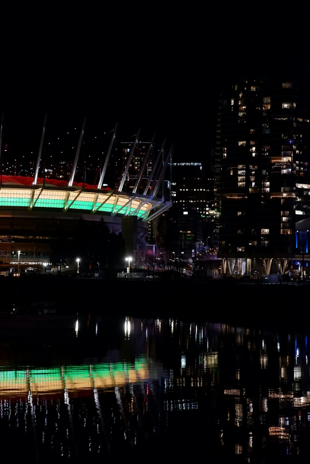 a bridge lit up at night over a body of water