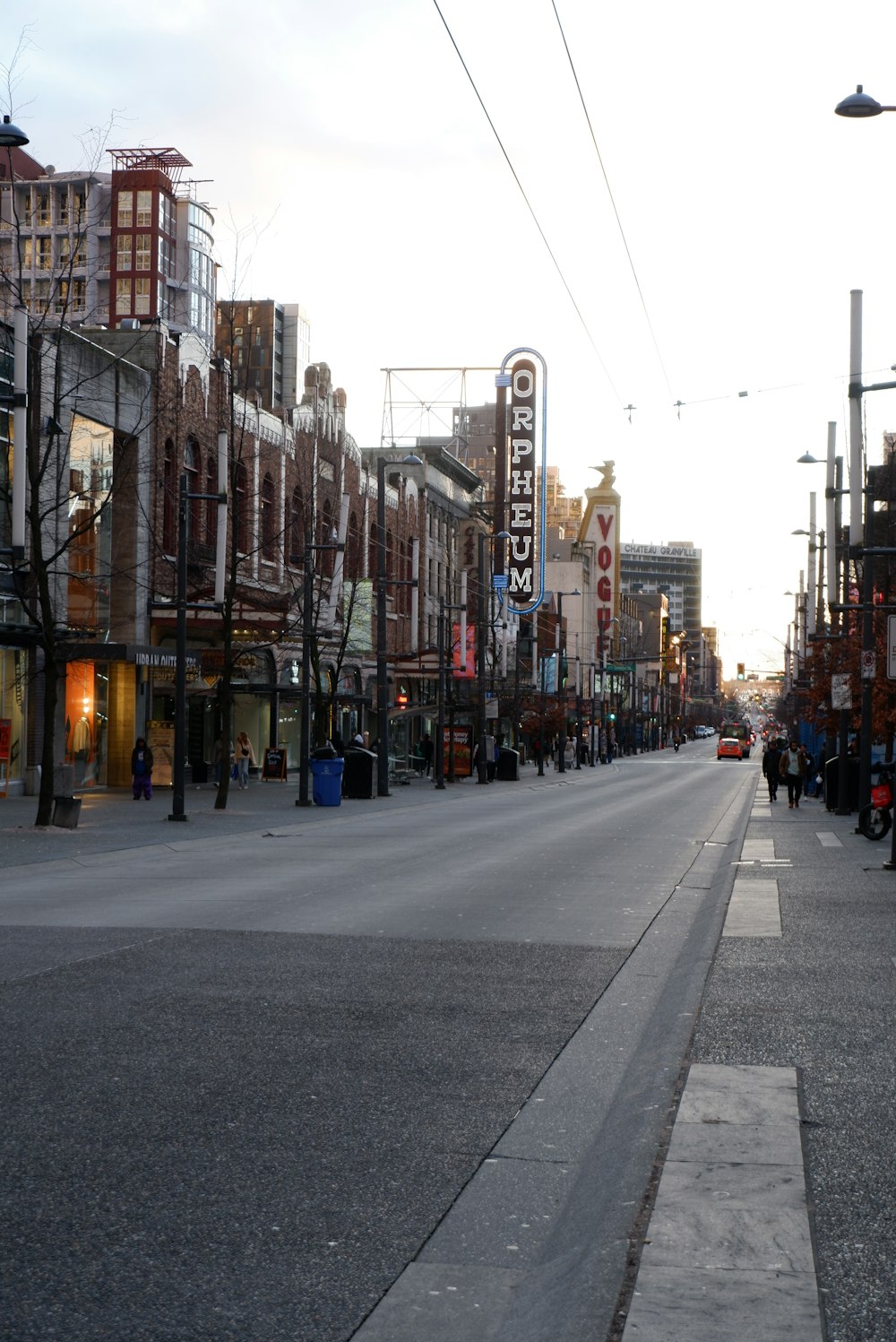 a city street lined with tall buildings and shops