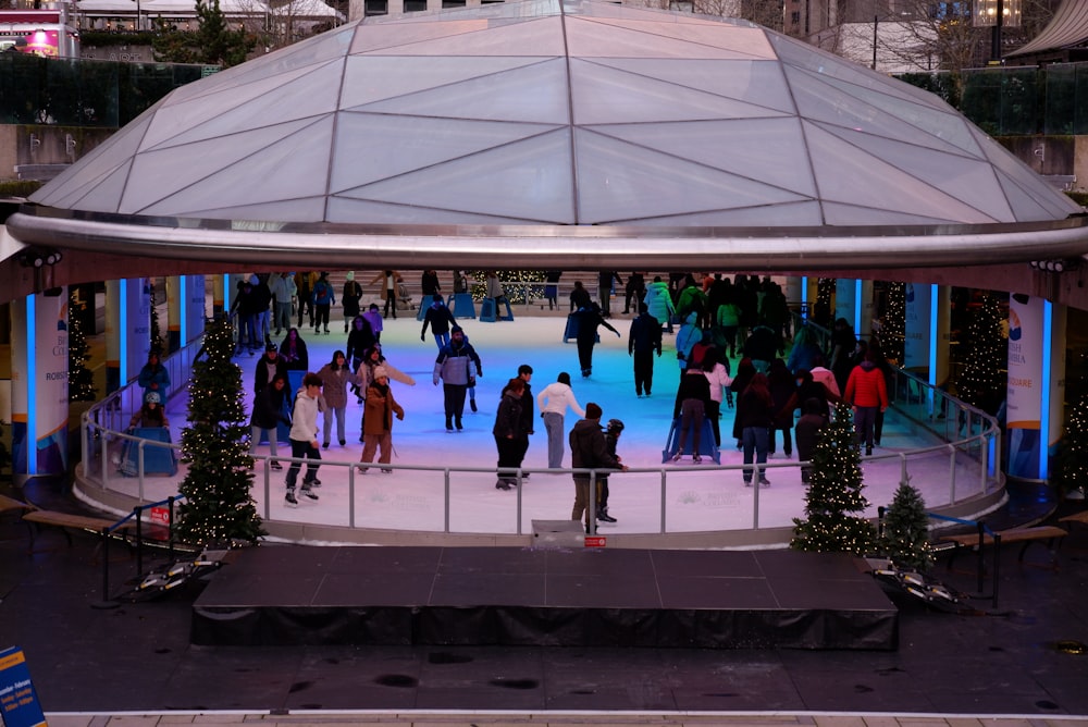 a group of people skating on an ice rink