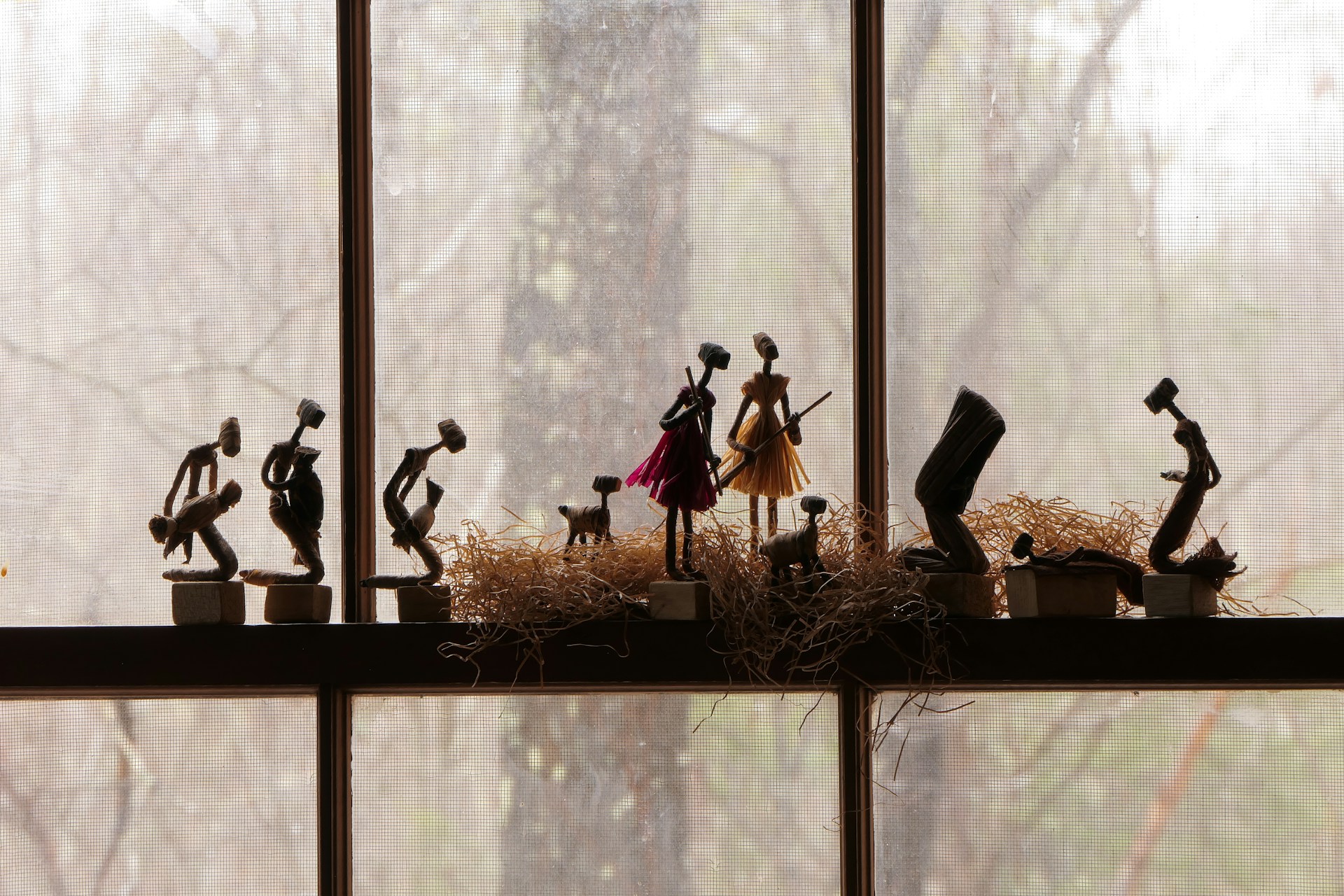 a group of figurines sitting on top of a window sill