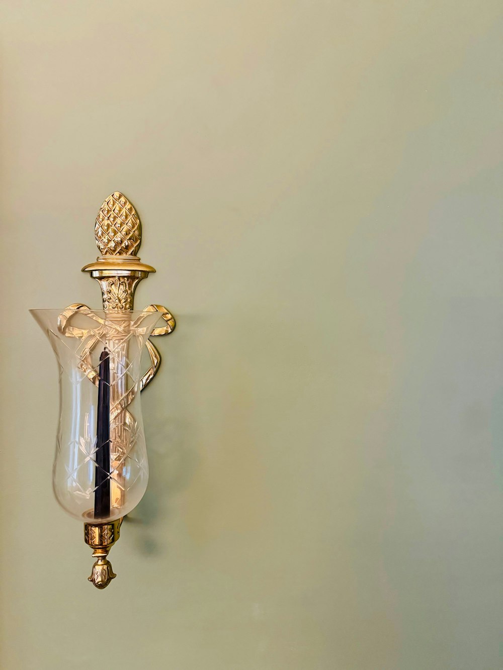 a wall light with a pineapple on the top of it
