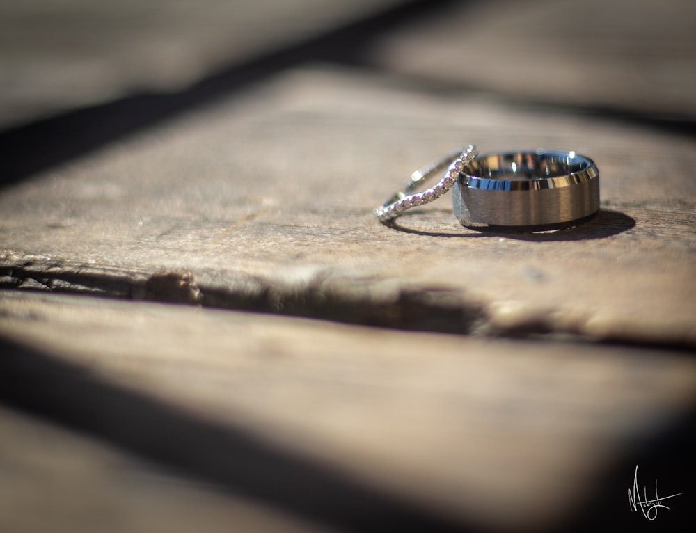 a couple of rings sitting on top of a wooden table