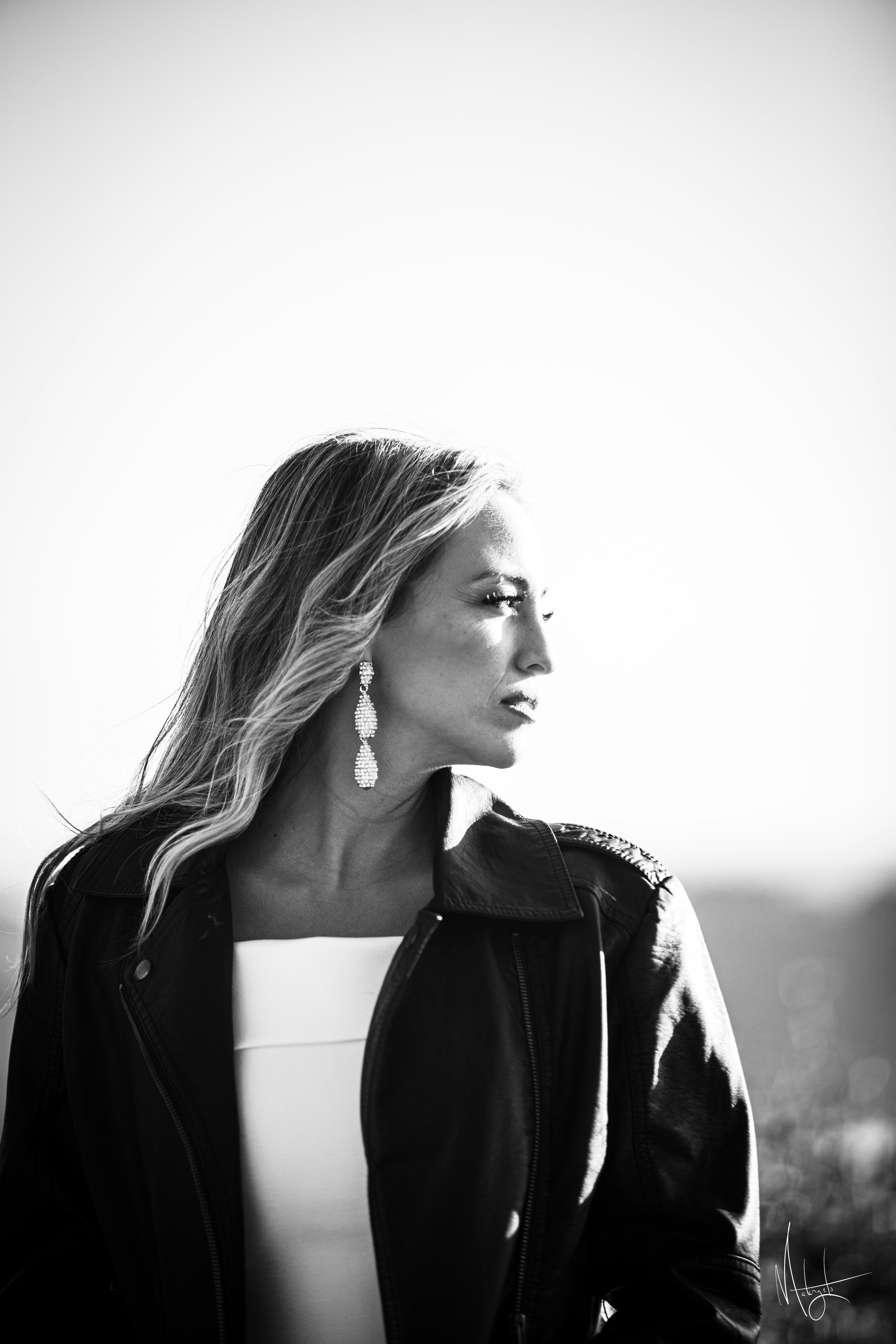 a woman in a black jacket and white top