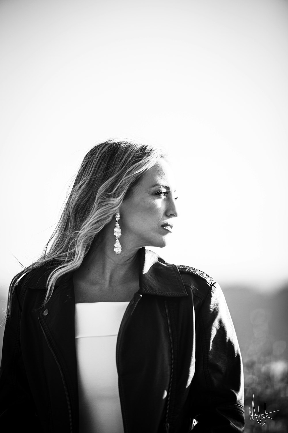 a woman in a black jacket and white top