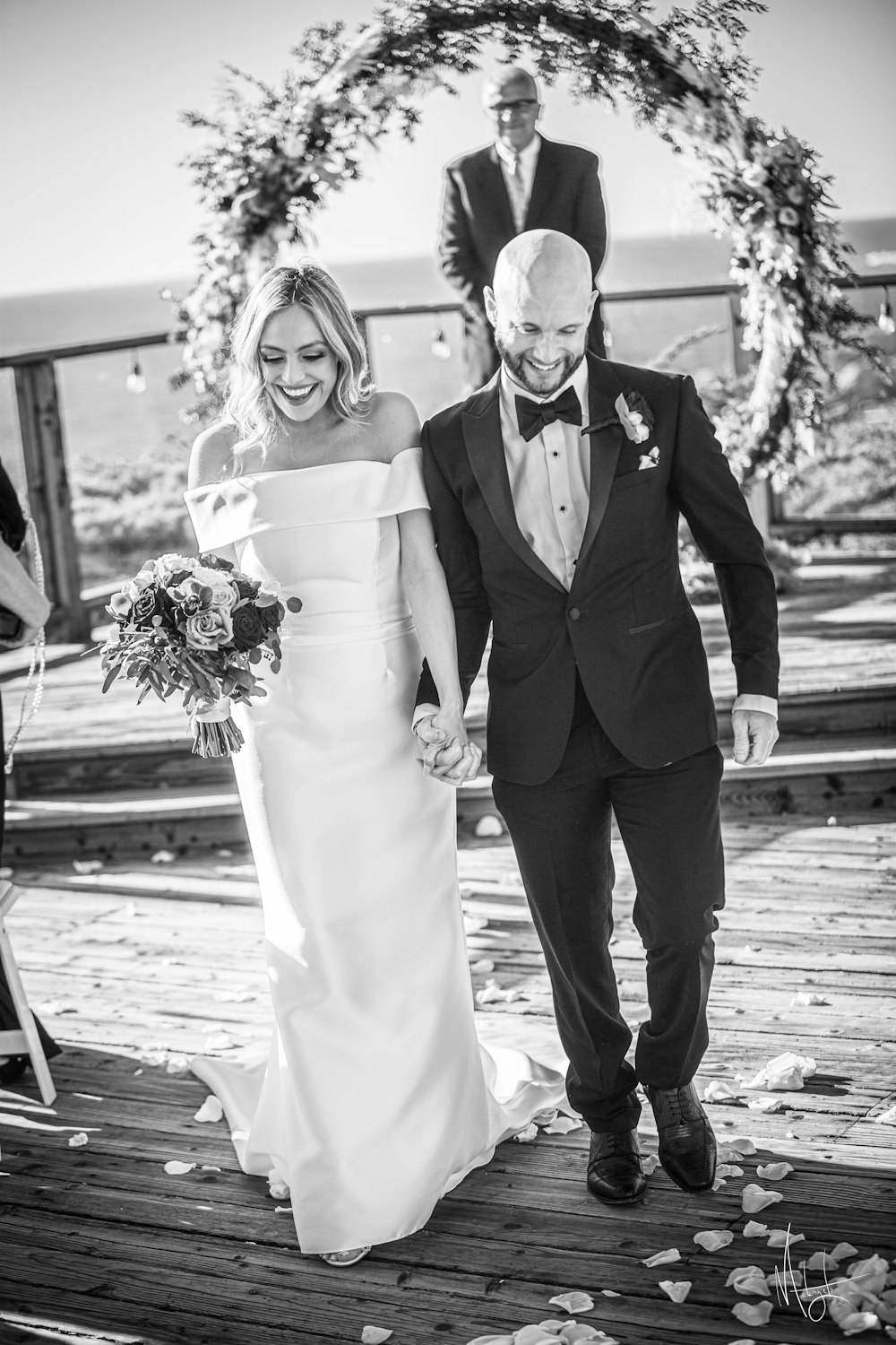 a bride and groom walking down the aisle