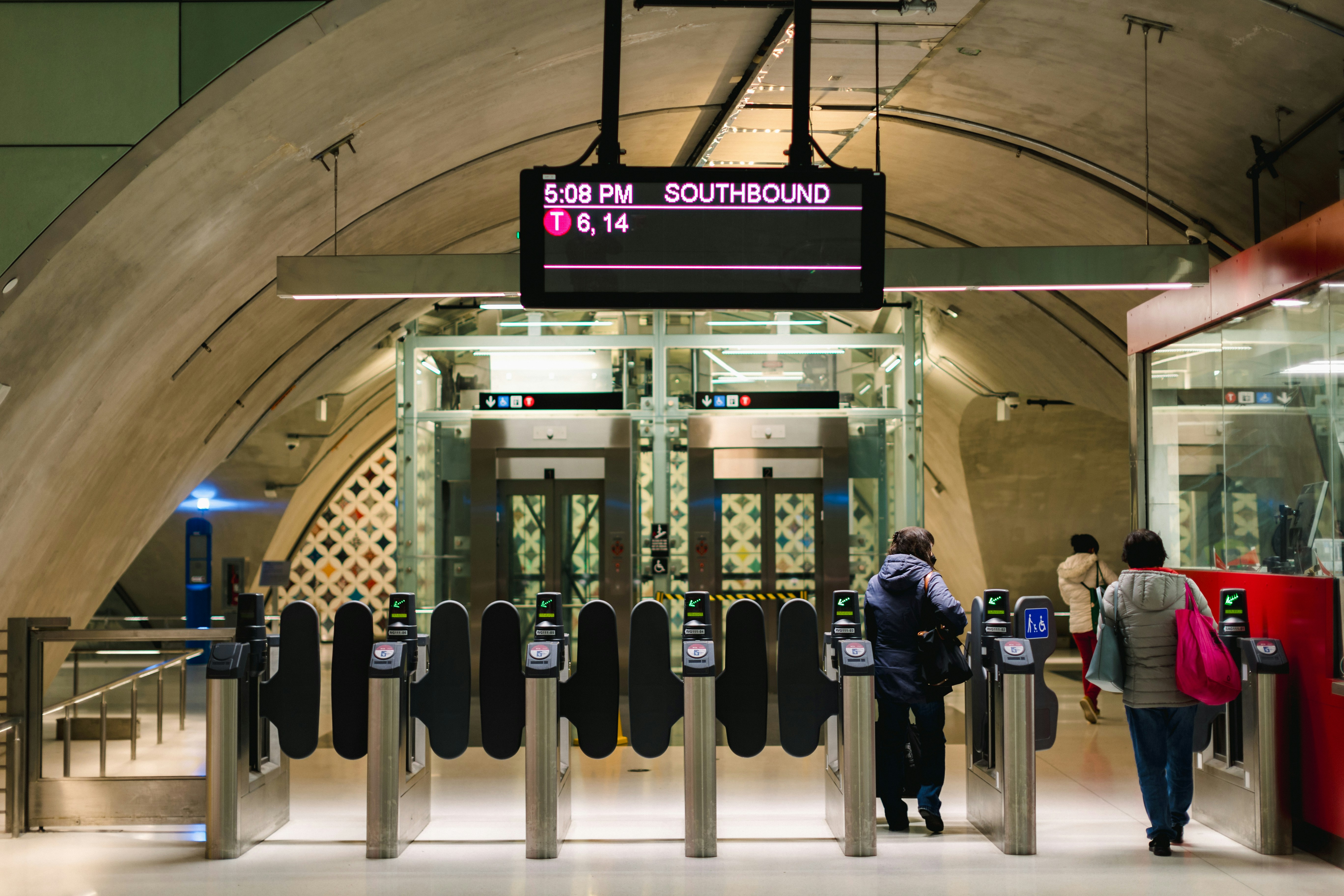 a couple of people standing at a train station