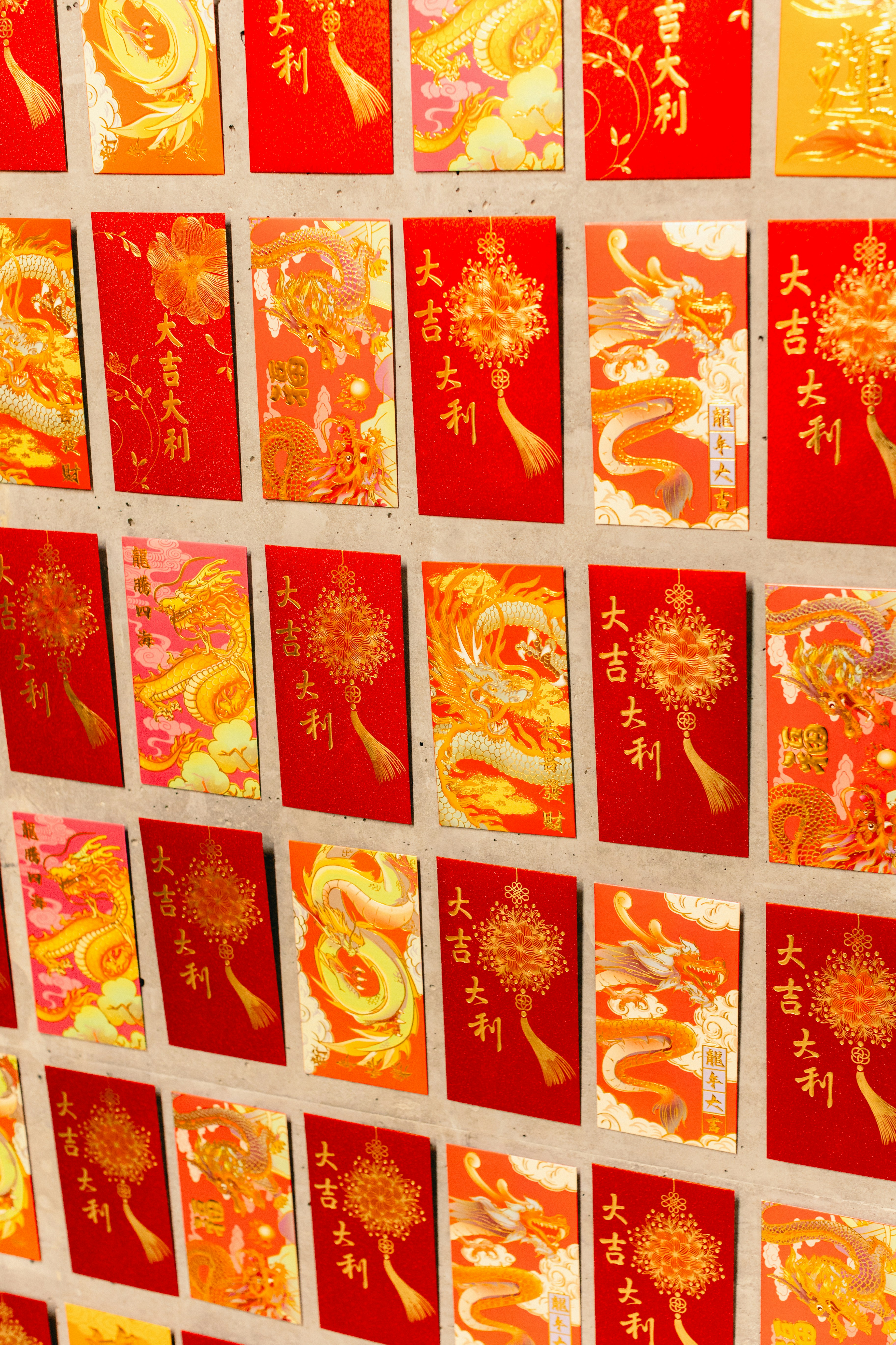 a bunch of red and yellow cards on a wall