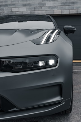 the front end of a gray sports car