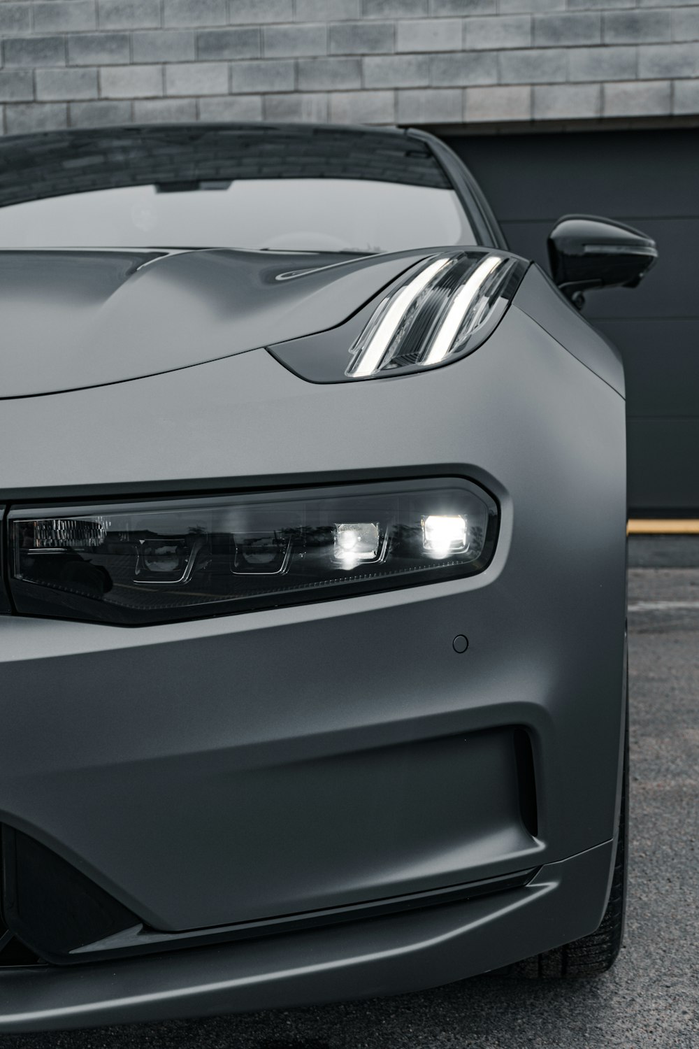 the front end of a gray sports car