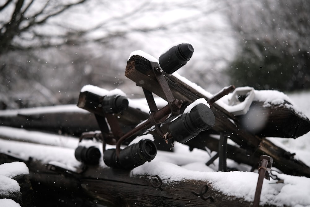 a bunch of old wooden objects covered in snow