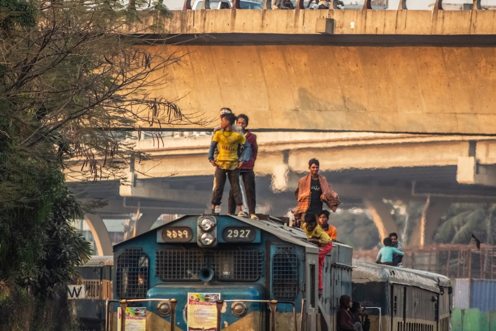 a group of people standing on top of a train