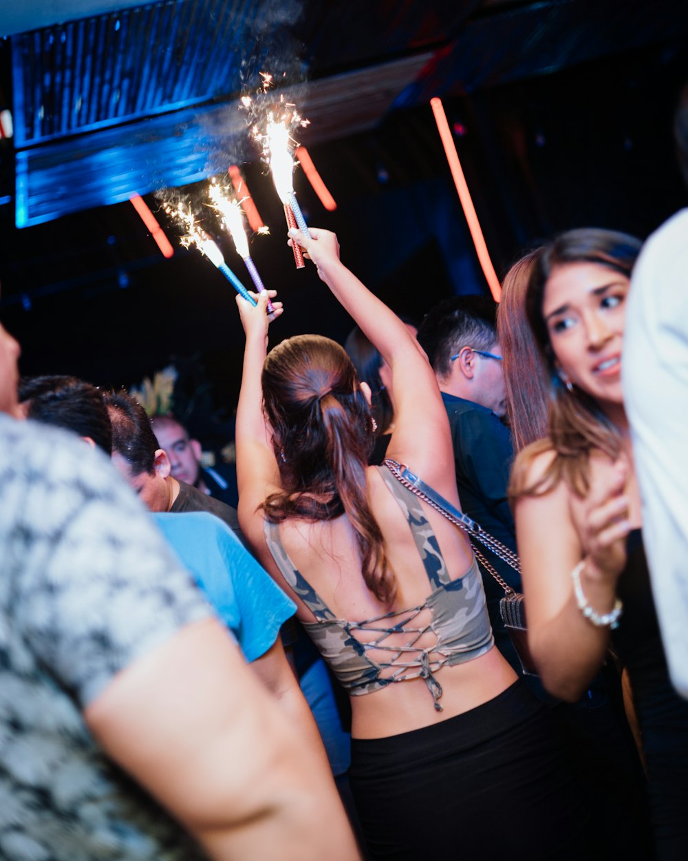 a group of people at a party with sparklers