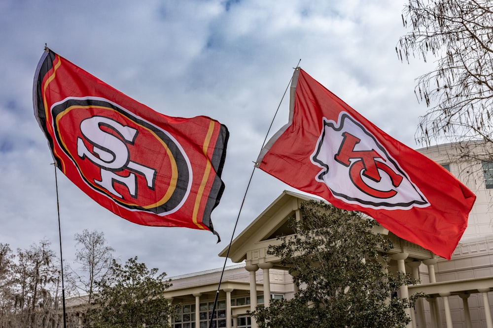 two san francisco giants flags in front of a building