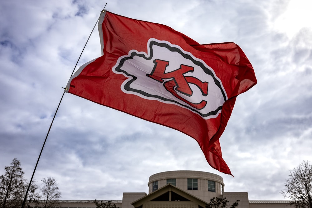 a kansas chiefs flag flying in front of a building
