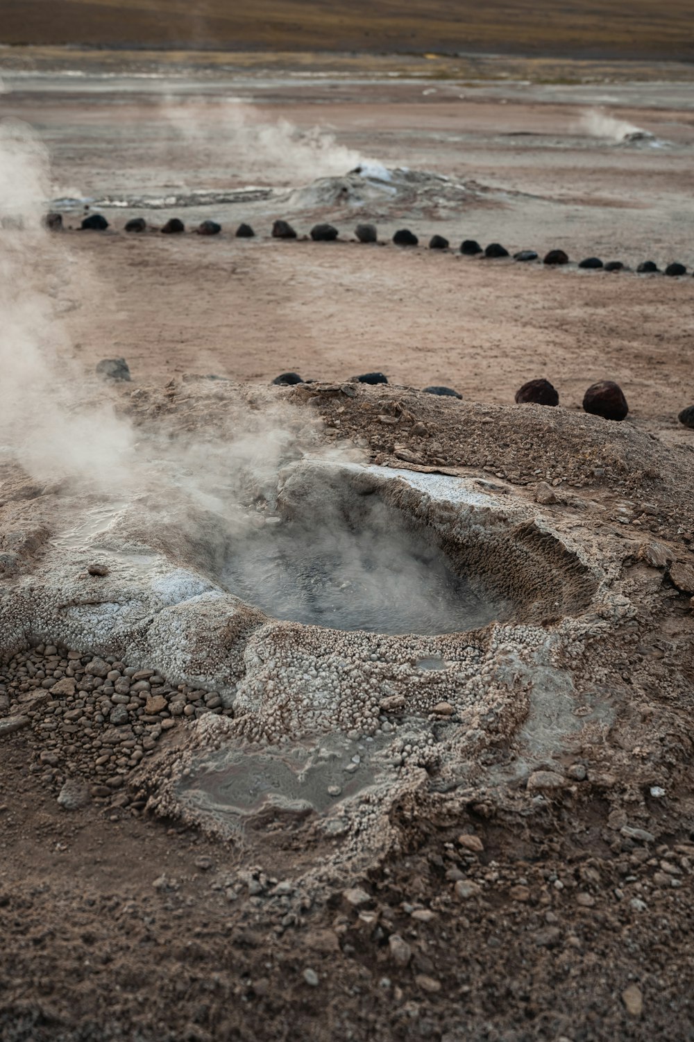 a hot spring in the middle of a barren area