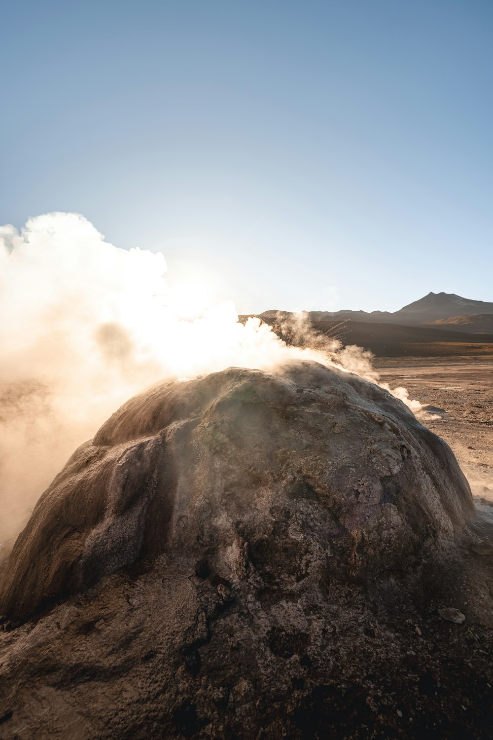 a large rock with steam coming out of it