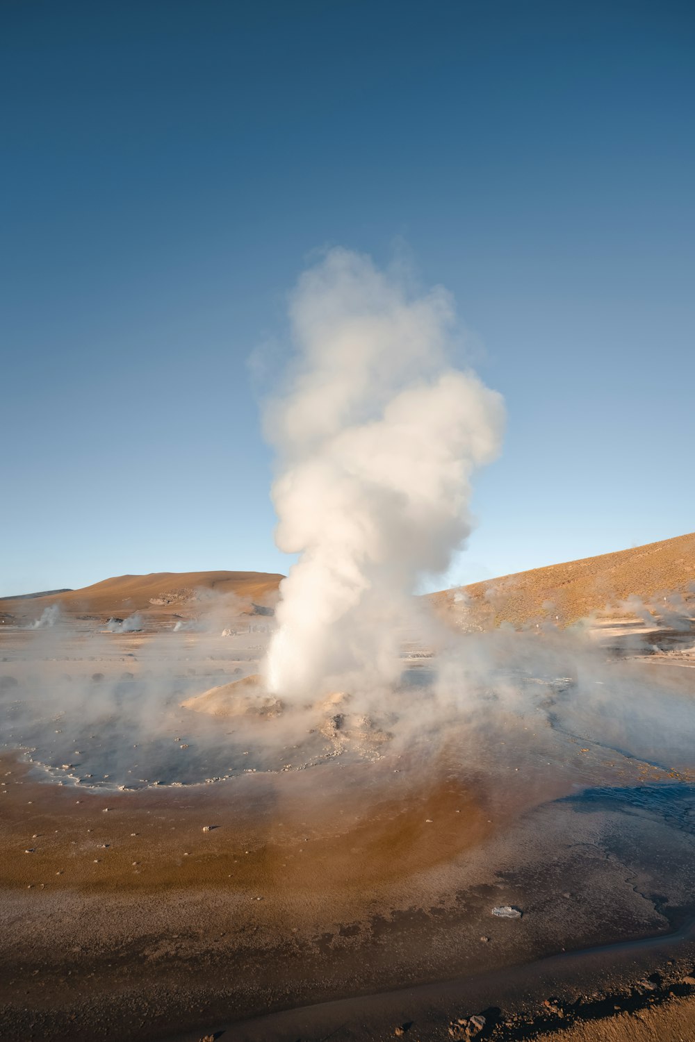 a geyser spewing out steam into the air