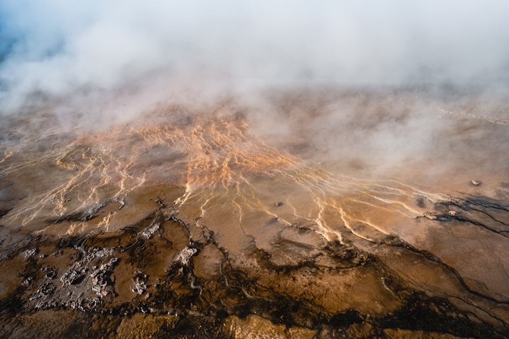 an aerial view of a barren area with steam rising from the ground