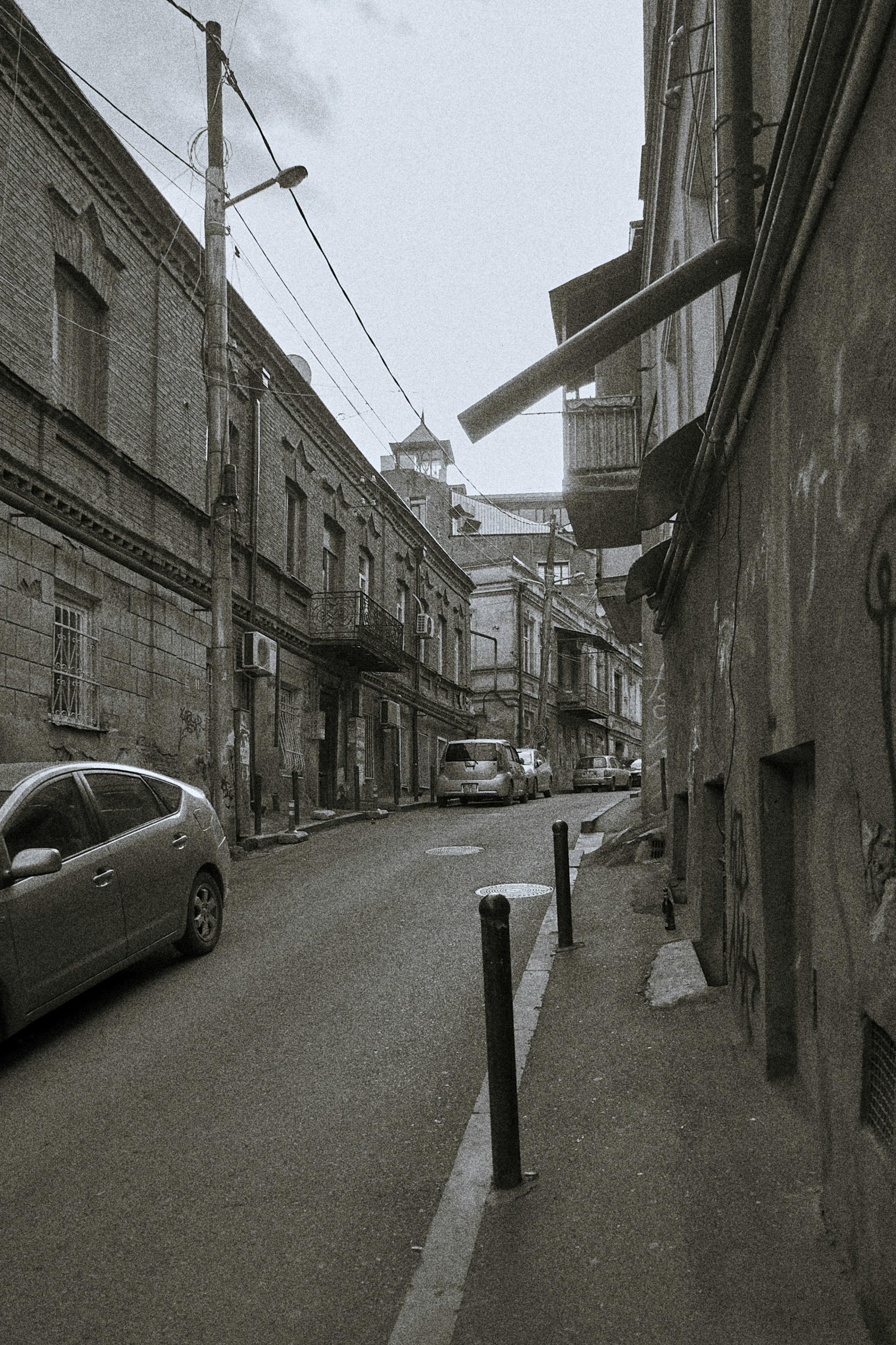 a car parked on the side of a road next to a building