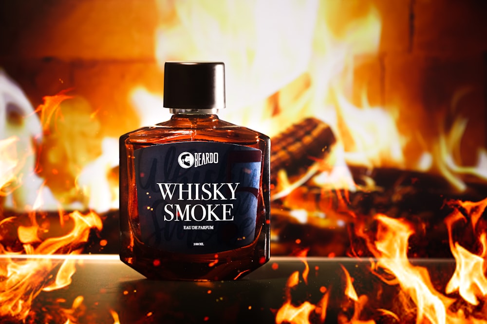 a bottle of whiskey sitting in front of a fire