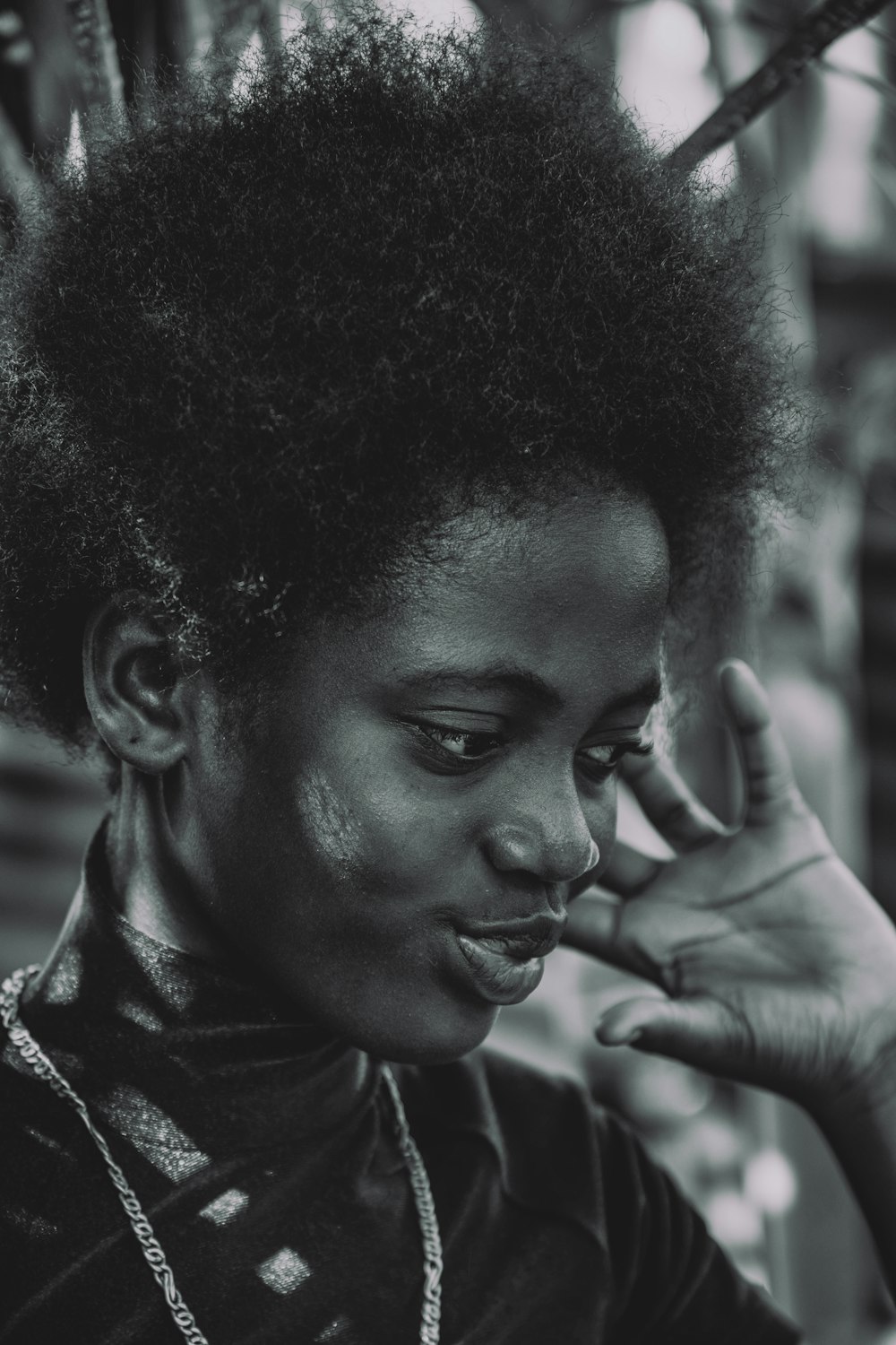 a black and white photo of a woman talking on a cell phone