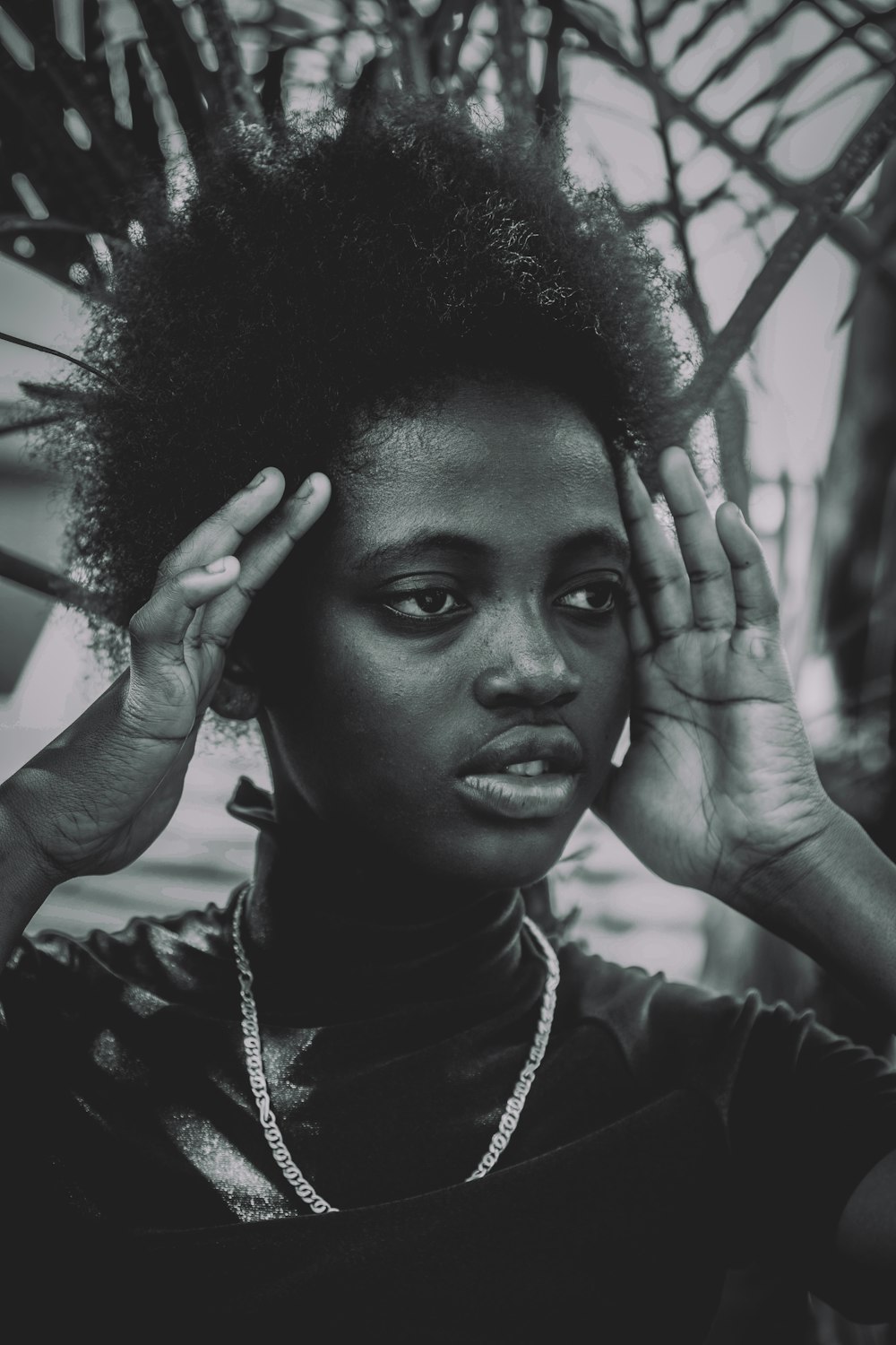 a black and white photo of a woman with an afro