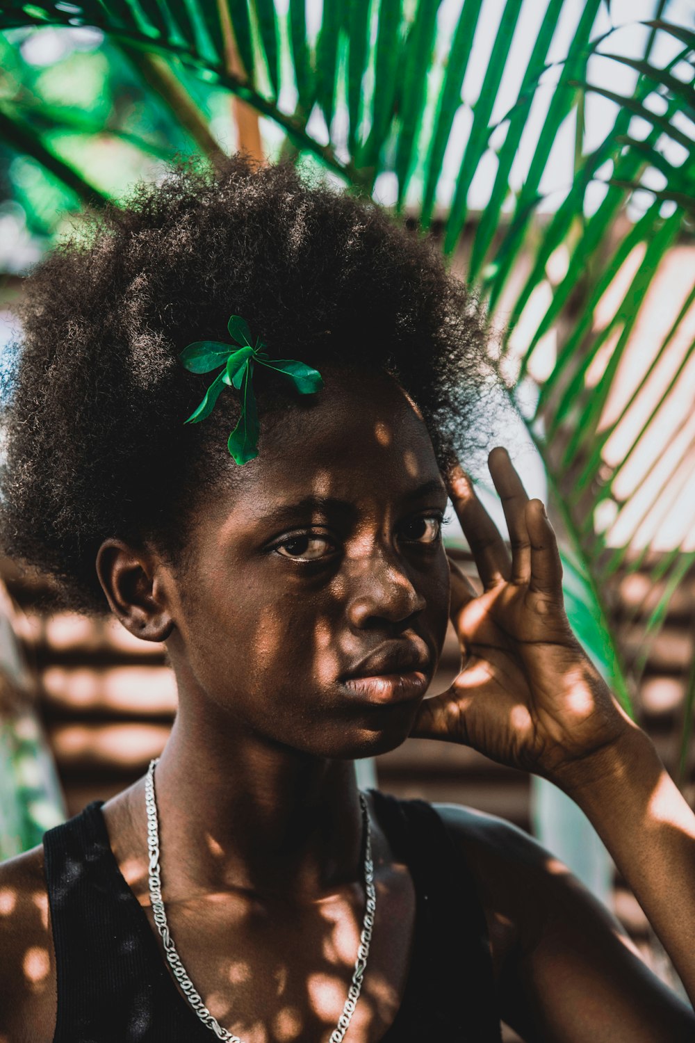 a woman with a green leaf on her head