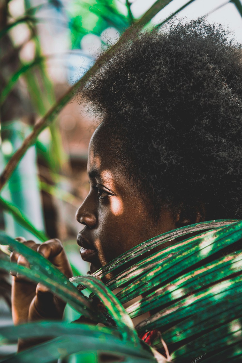 a close up of a person holding a plant