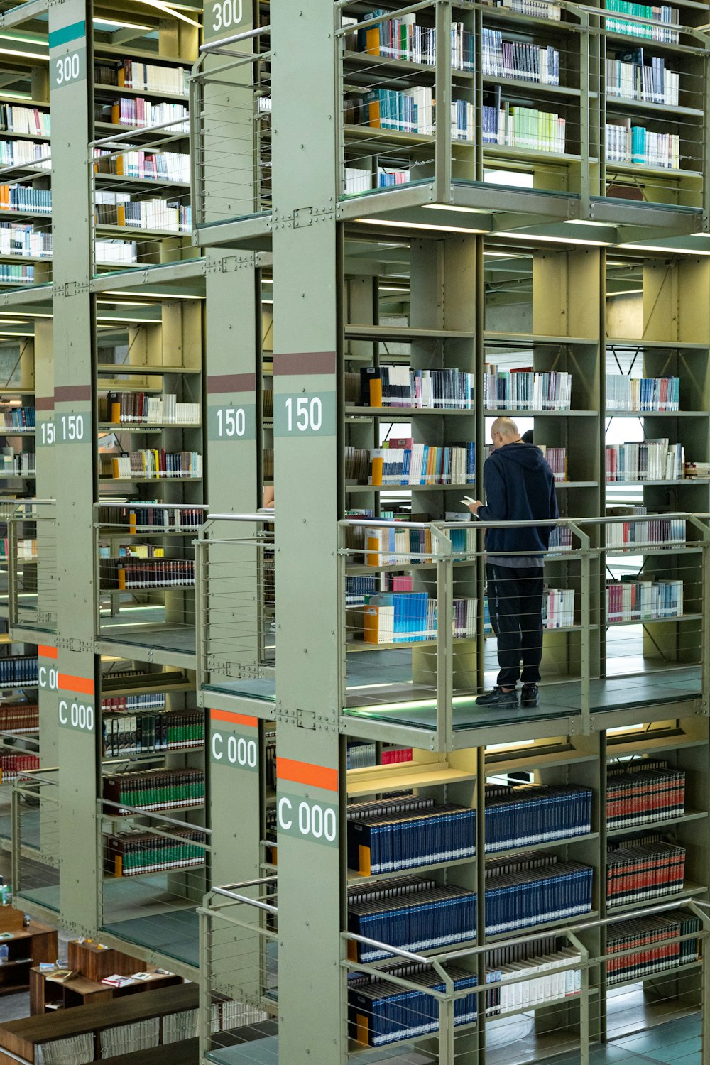 a man standing in a library filled with lots of books