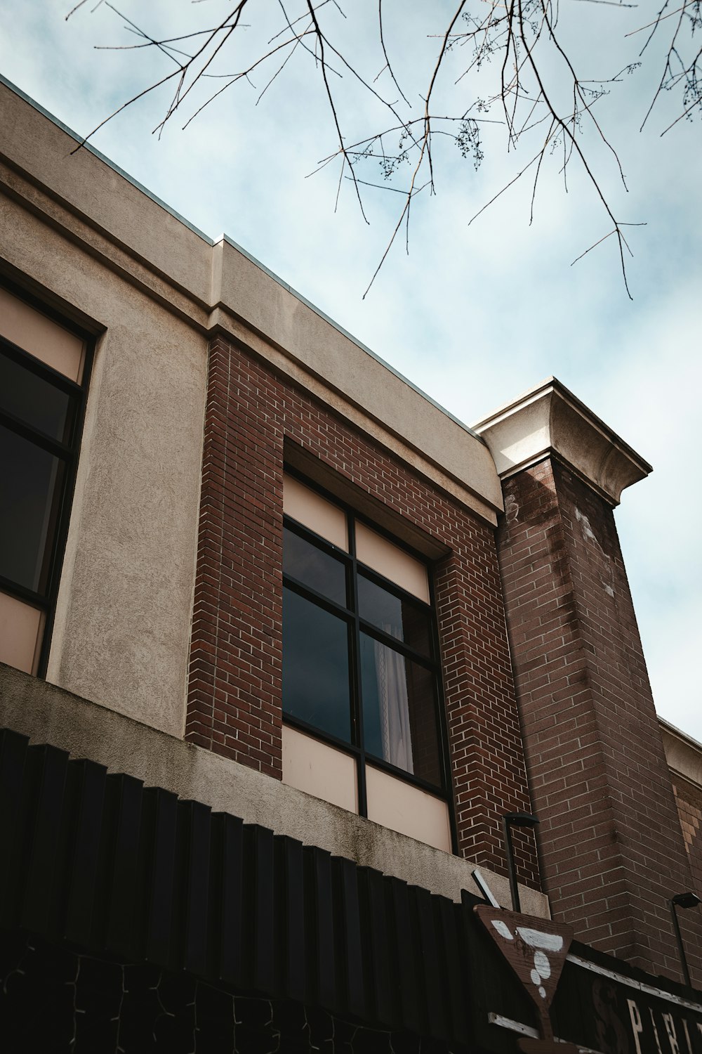 a tall brick building sitting next to a street sign