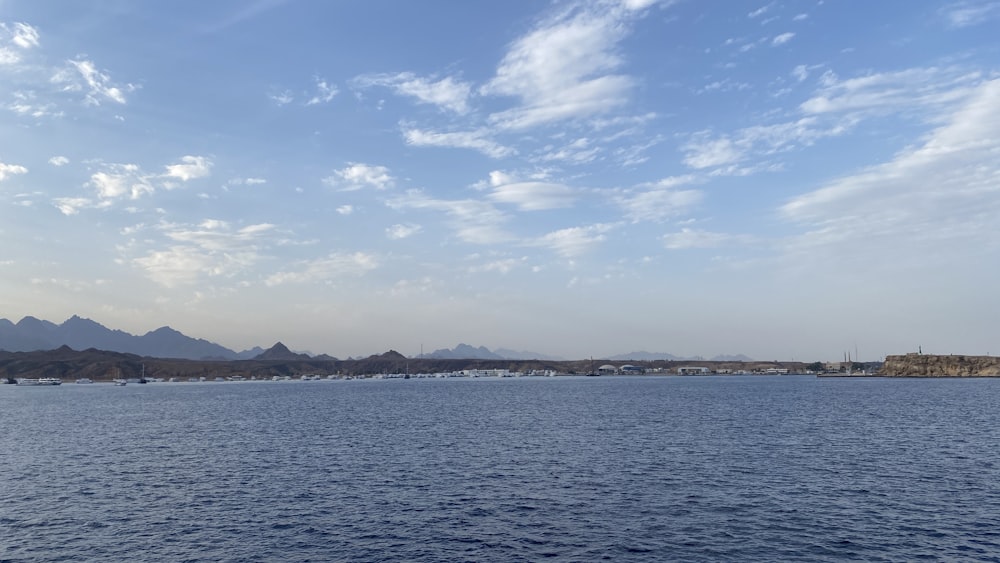 a body of water with mountains in the background