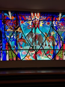 a large stained glass window with an elephant on it