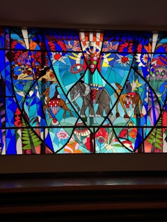 a large stained glass window with an elephant on it