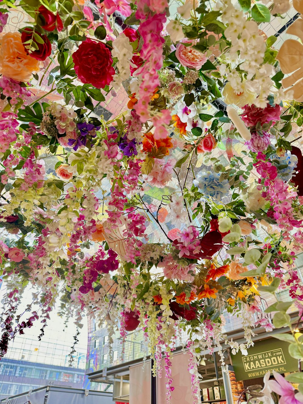 a bunch of flowers that are hanging from a ceiling