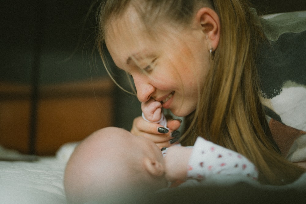 eine Frau, die ein Baby auf dem Schoß hält