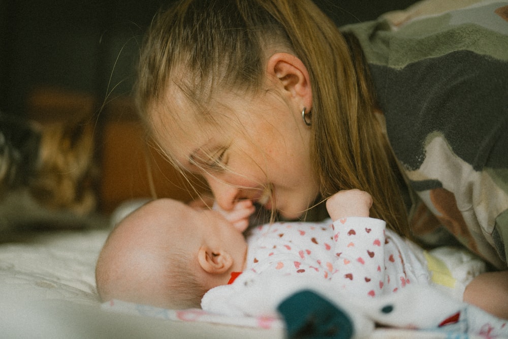 a woman holding a baby in her arms