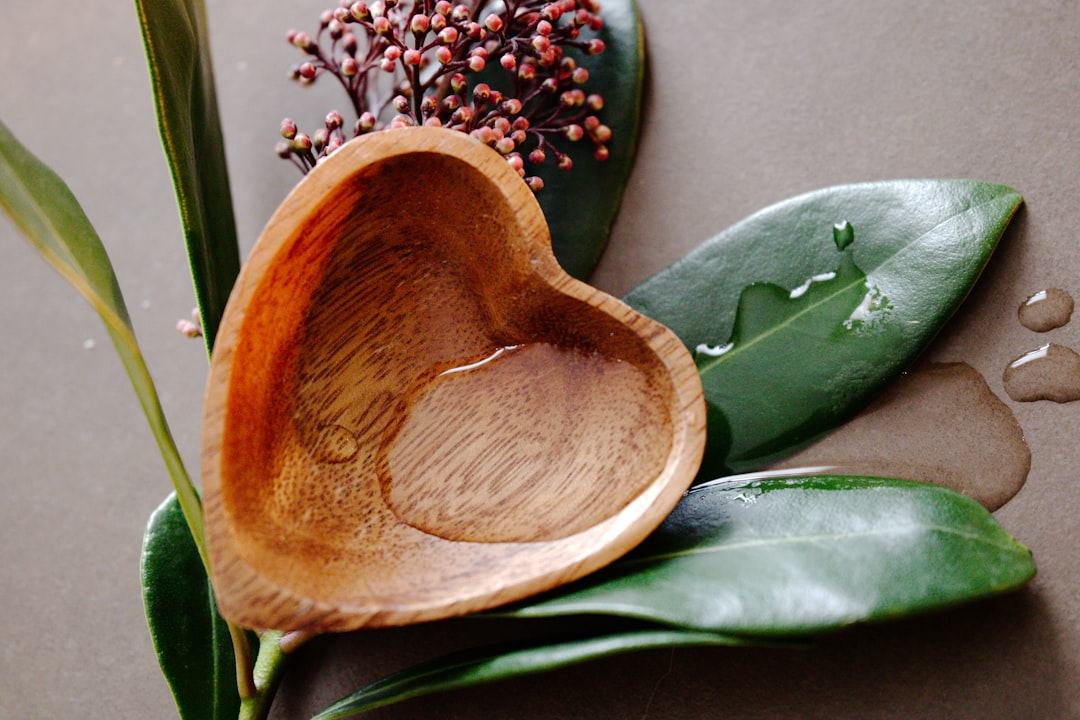 a wooden spoon sitting on top of a leafy plant,