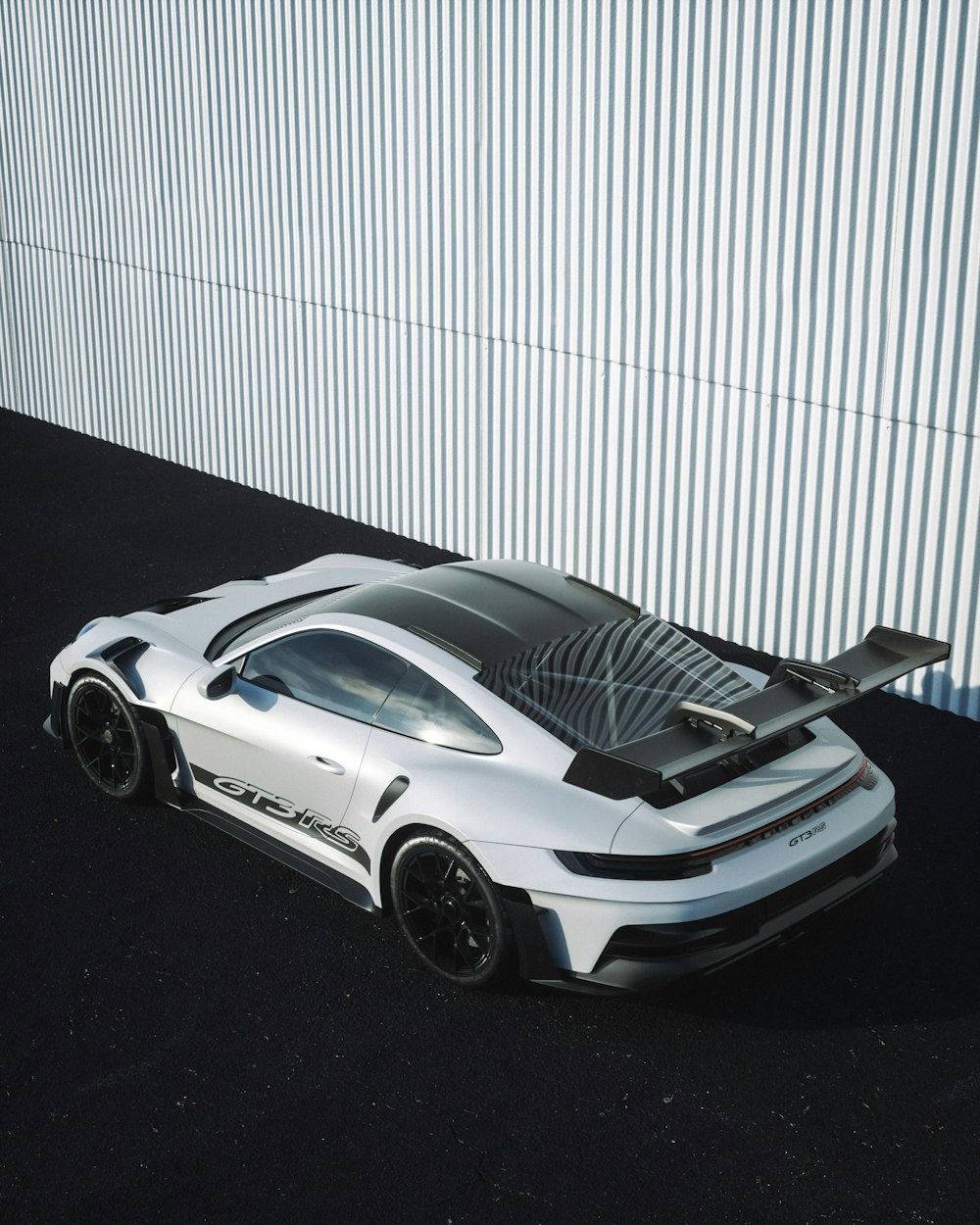 a white sports car parked in front of a building