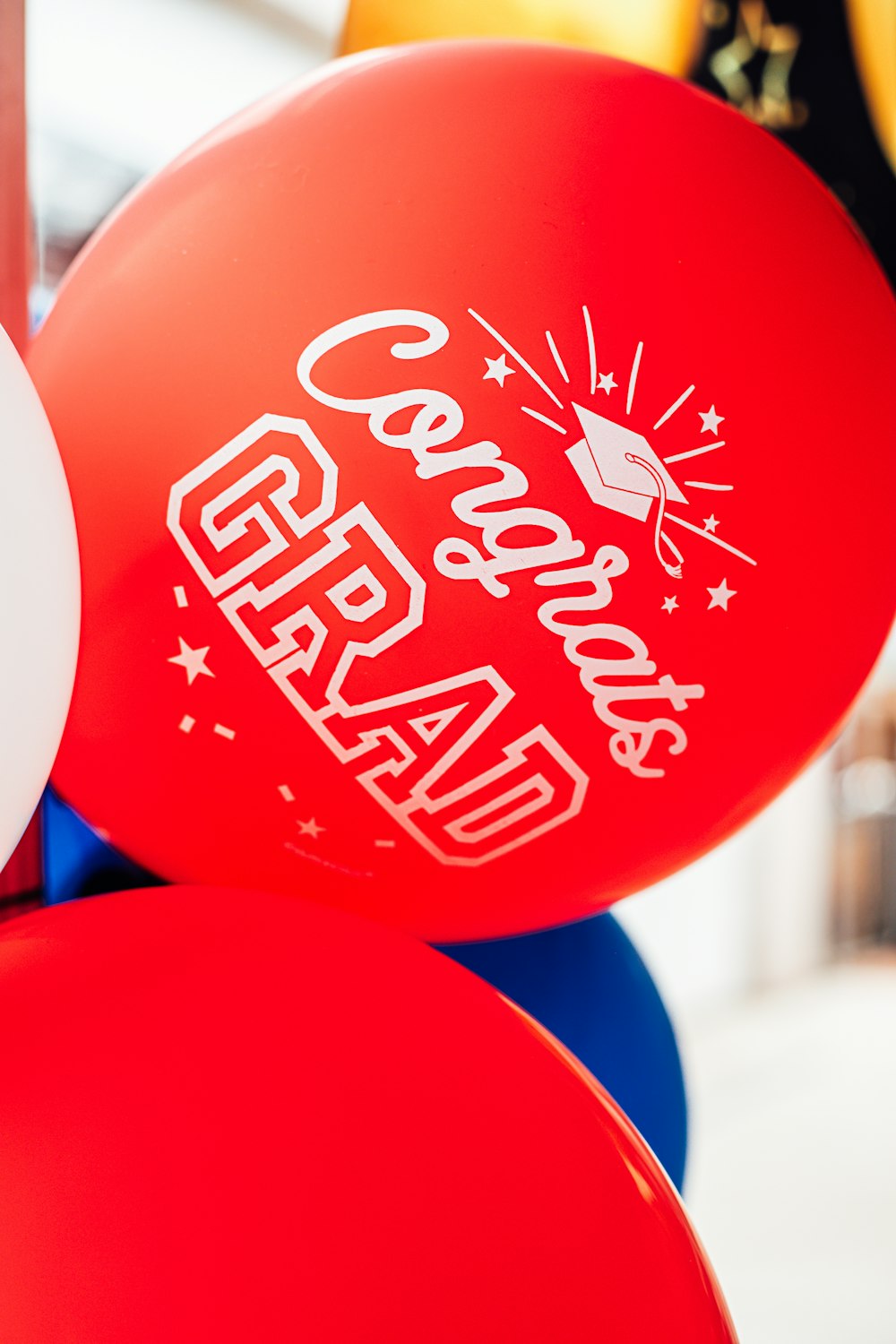 a bunch of red and blue balloons with white lettering