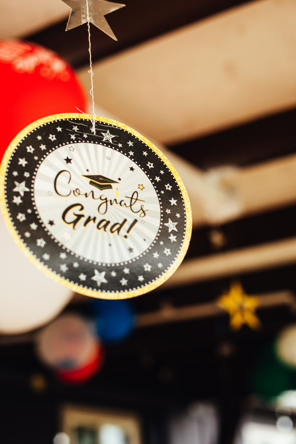 a graduation decoration hanging from a ceiling