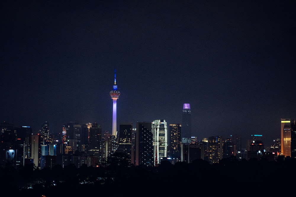 a view of a city at night from a hill