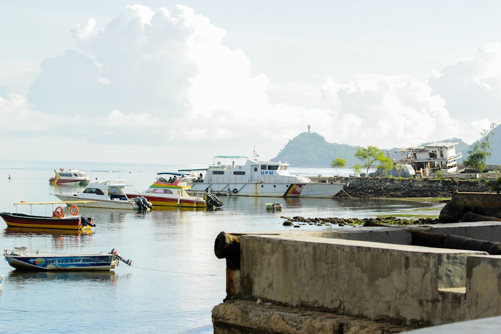 a group of boats floating on top of a body of water