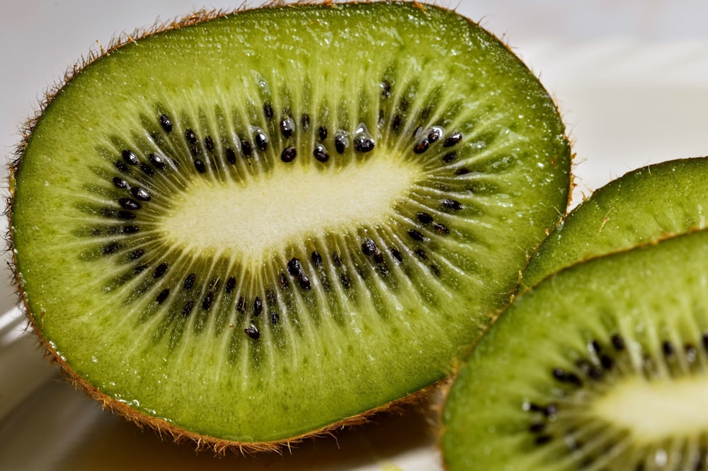 a kiwi cut in half sitting on a plate