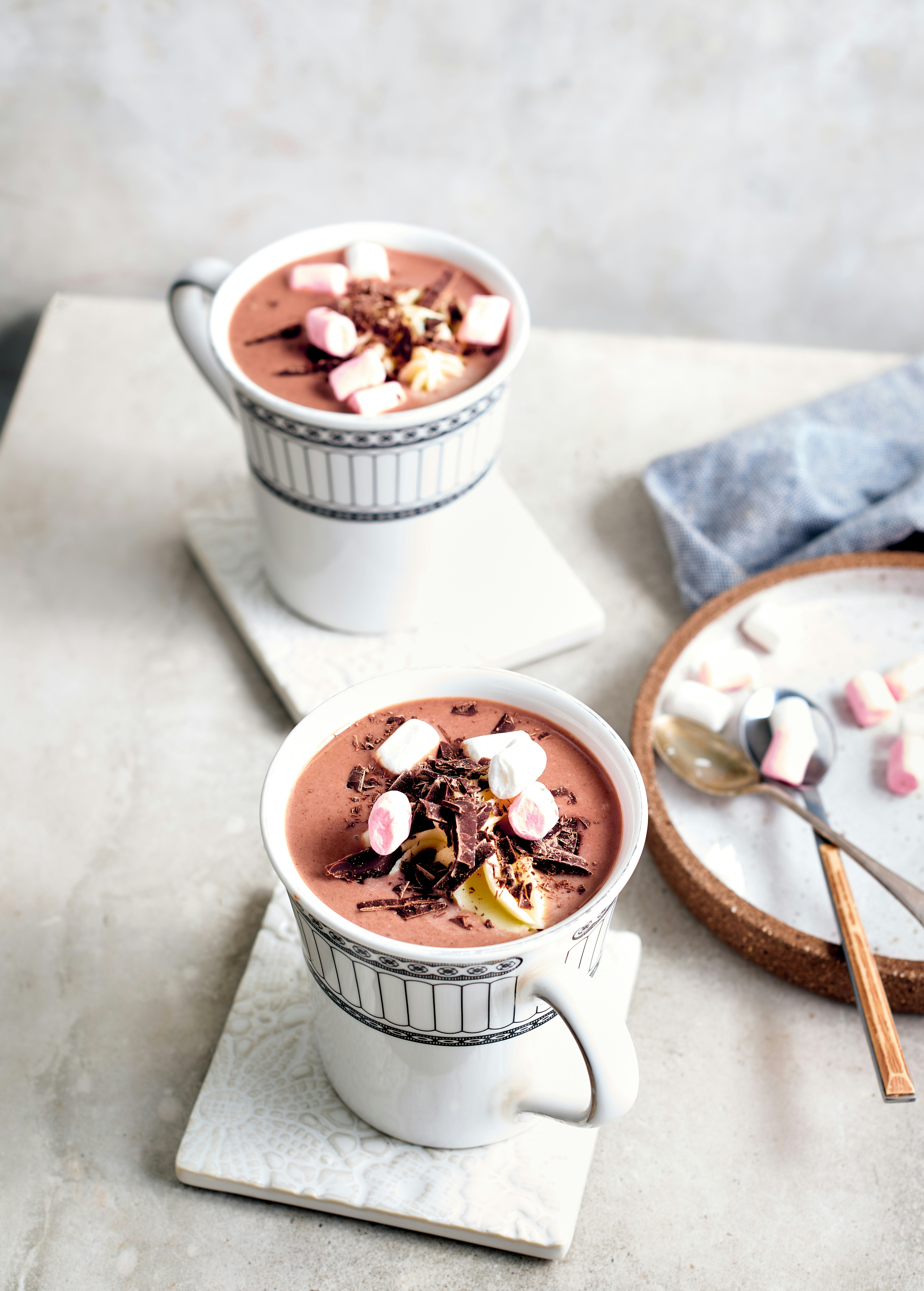 two cups of hot chocolate with marshmallows on top