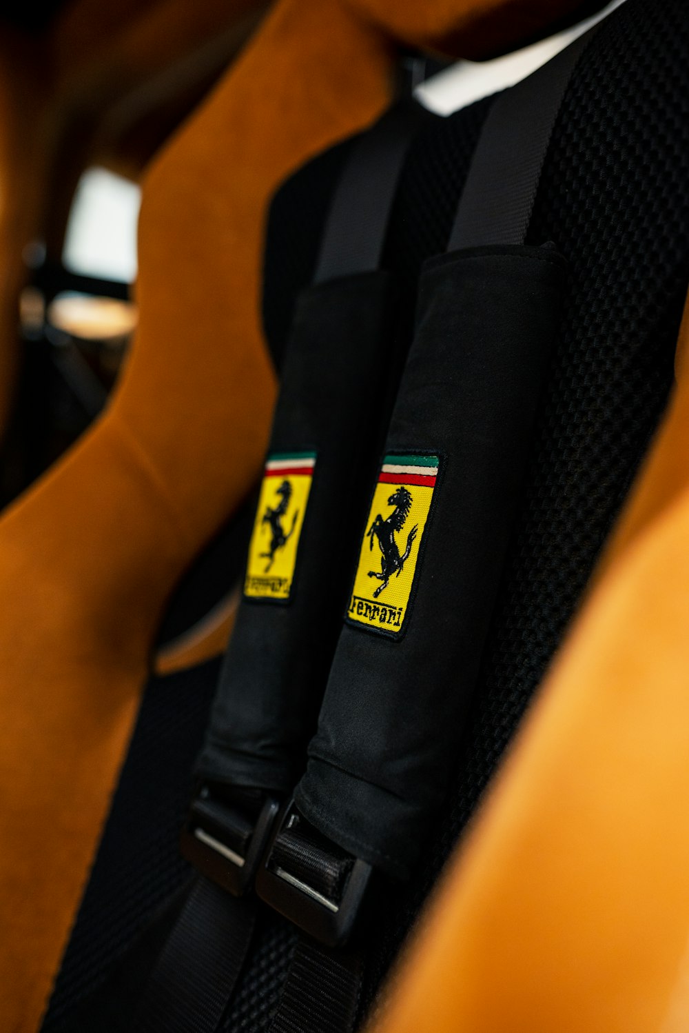 a close up of a seat belt with a ferrari logo on it